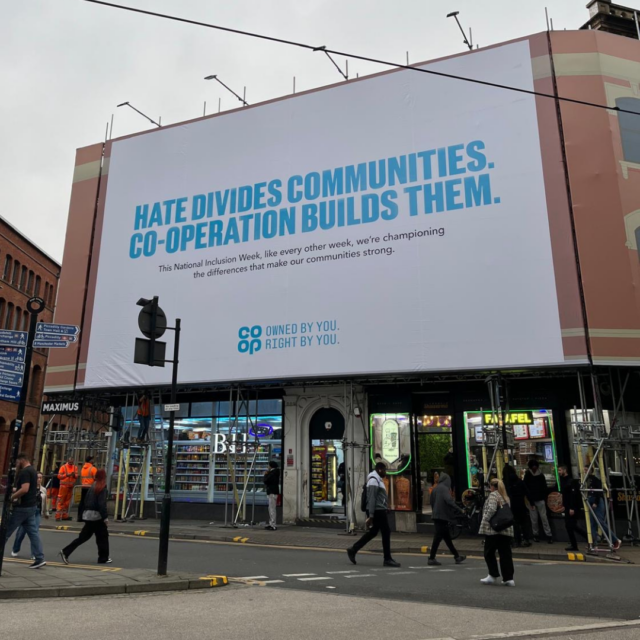 Co-op billboard which says: Hate divides communities. Co-operation builds them.