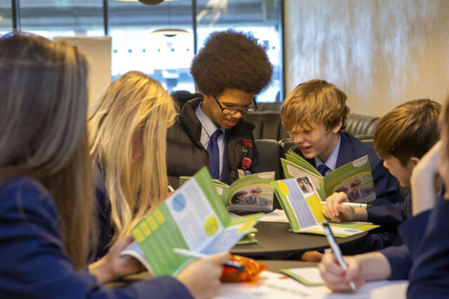 Group of young people looking at exercise books