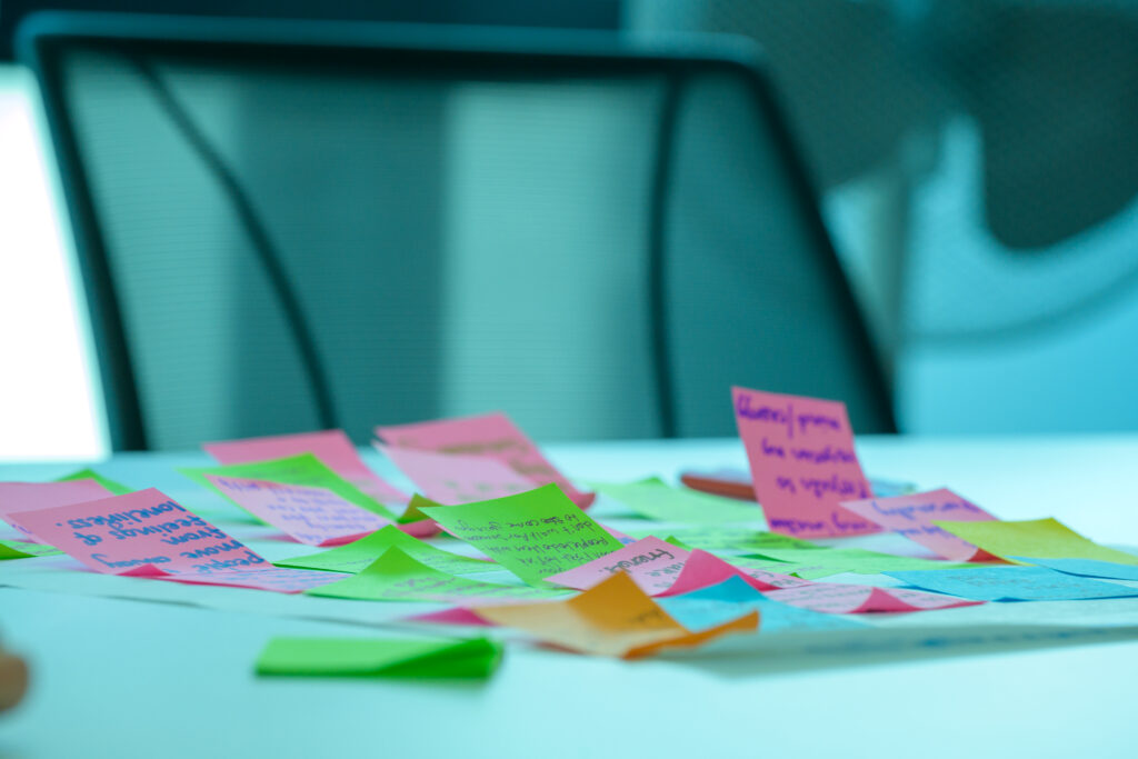 Brightly coloured post-it notes on a large piece of paper